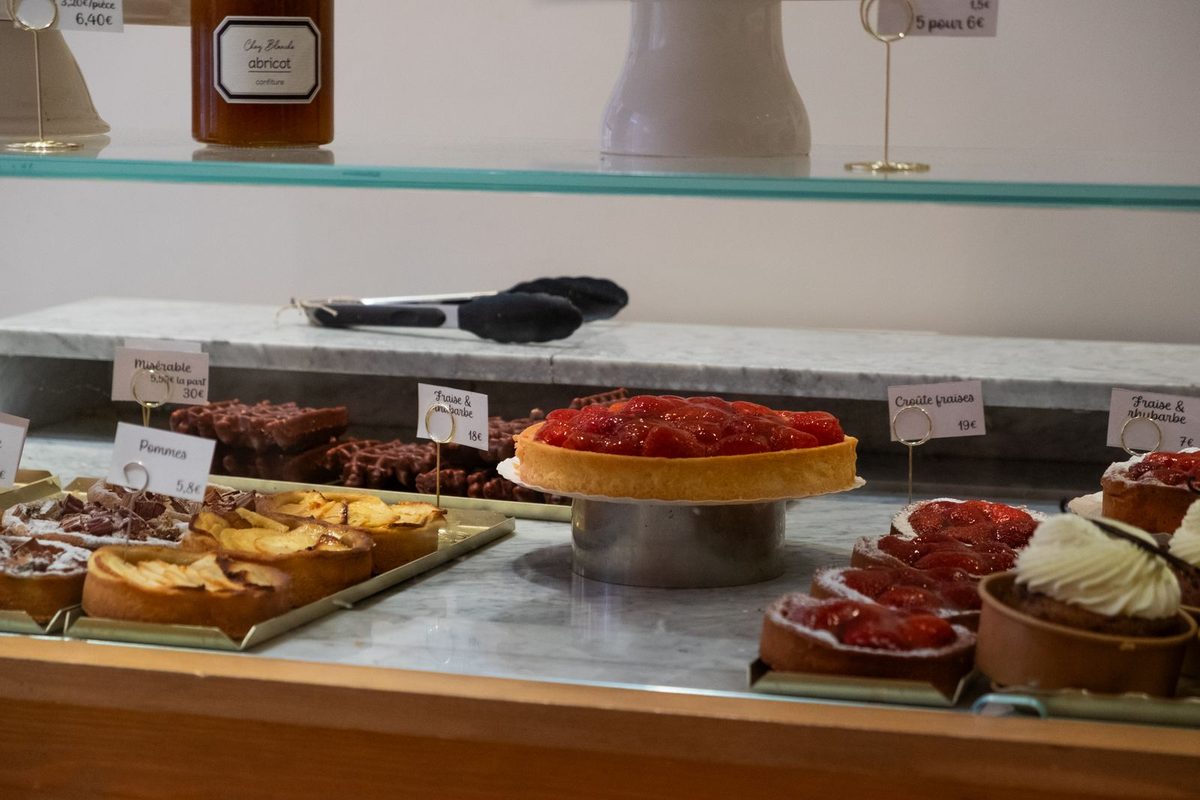 Vitrine de pâtisserie garnie de tartes et d'entremets
