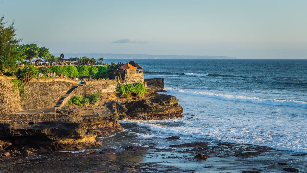 Le temple de Tanah Lot perché sur un rocher face à l'océan à Bali au coucher du soleil